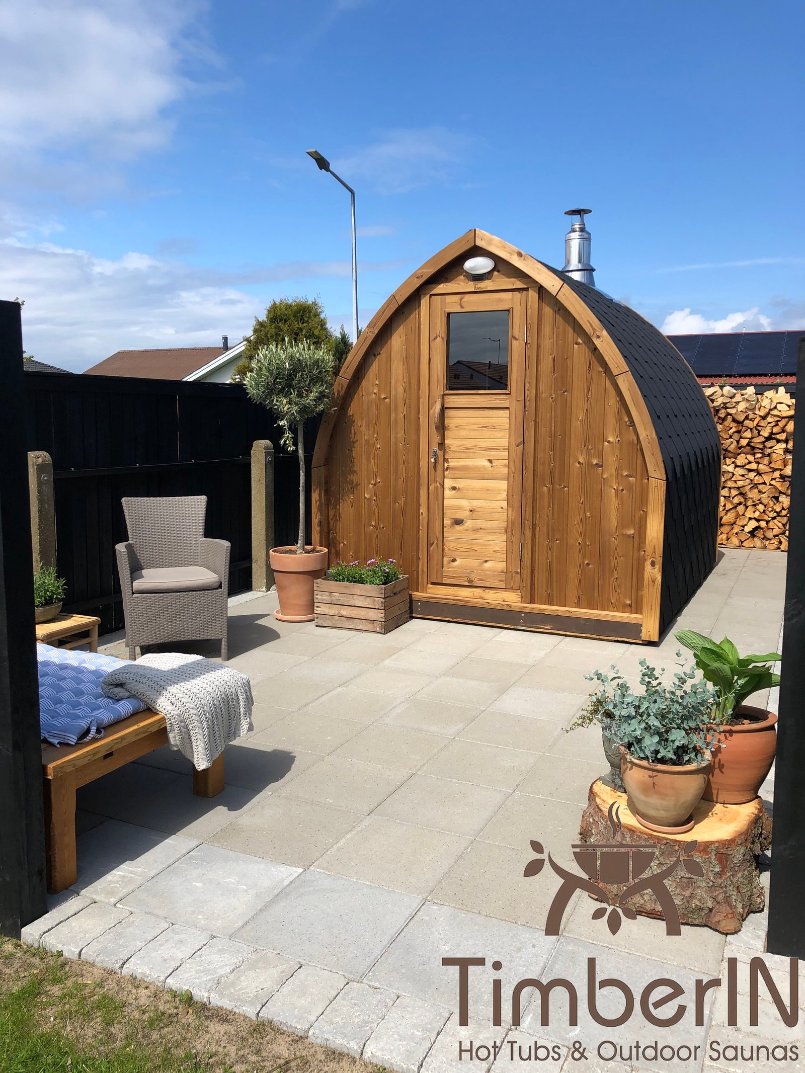 TimberIN® Danmark 12 Pod-sauna i træ på en flisebelagt terrasse