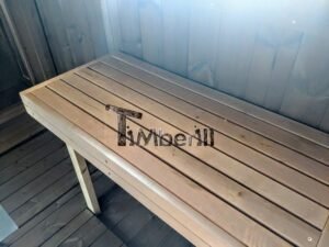 TimberIN Nordic Oval™ Terrace – udendørs sauna med terrasse, med synlige træbænke, på en træterrasse