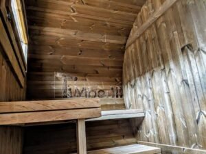 TimberIN Nordic Oval™ Terrace – udendørs sauna med terrasse set indefra, med synlige træbænke og synligt vindue