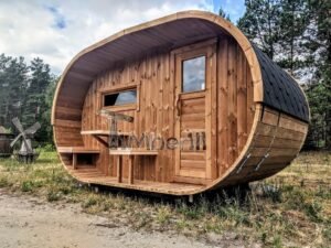 TimberIN Nordic Oval™ Terrace – udendørs sauna med terrasse set indefra, med synlig trædør og synligt vindue, i en anlagt have